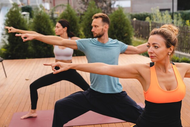 Stretching 3540s group of people before work out outdoors