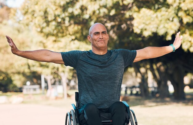 Stretching fitness and wheelchair user in park for workout health and muscle relief Man with a disability training and wellness exercise with mature person in warm up nature and sports challenge