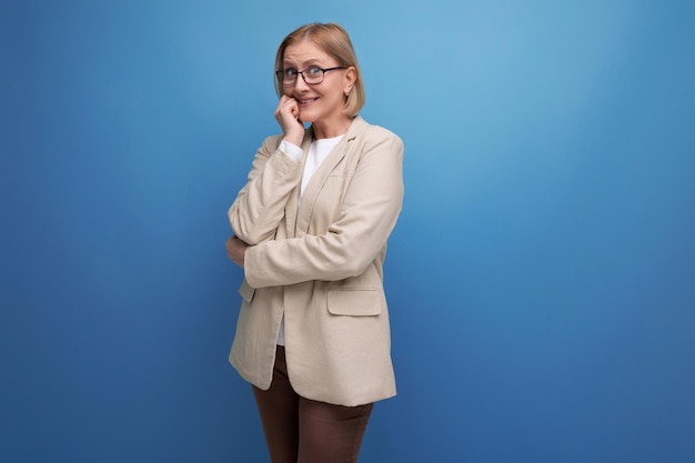 A strict serious adult woman with a bob haircut stands thoughtfully on a bright background with copy