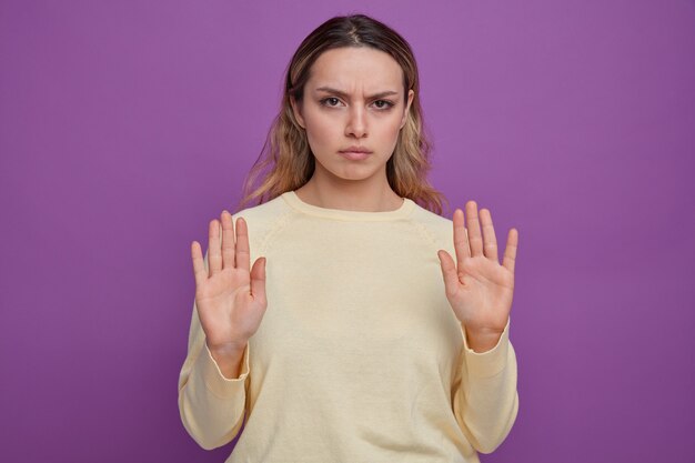 Strict young girl doing stop gesture 