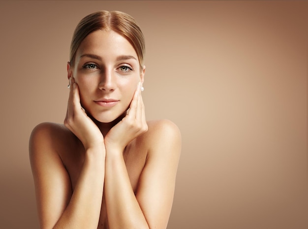 Stright portrait of attractive woman on a warm background