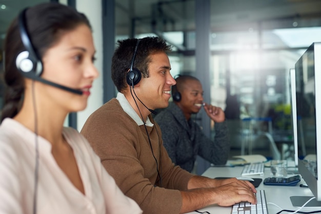 Striking sales one after another Shot of call centre agents working in an office