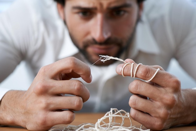 Photo string thread and man with eye of needle for stitching sewing and needlework in fashion industry struggle concentration and hands of person with tools for material textile and tailor business