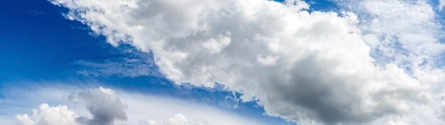 Strip of white clouds in the blue sky in sunny weather