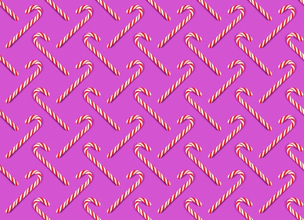 Striped Christmas red and white lollipops on a pink background Seamless pattern