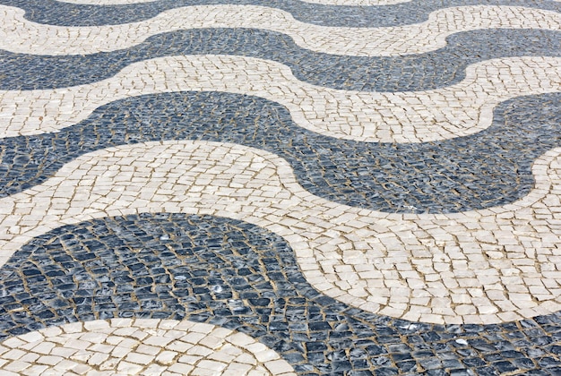 Striped cobbled road in town as background.