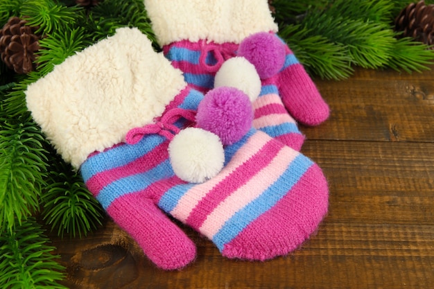 Striped mittens with fir wooden table