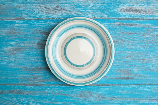 Striped plate on wood background