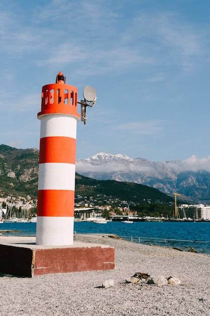 A strisce rosse e bianche in tivat montenegro contro la cima innevata del monte lovcen