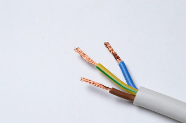 the stripped three-core wire lies on a light background. close-up