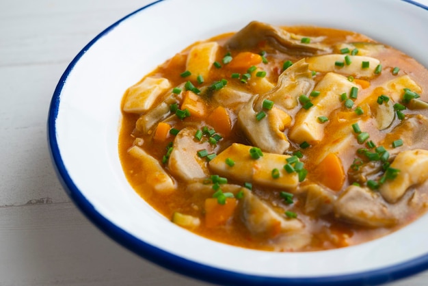 Strips of squid stewed with potatoes vegetables and broth