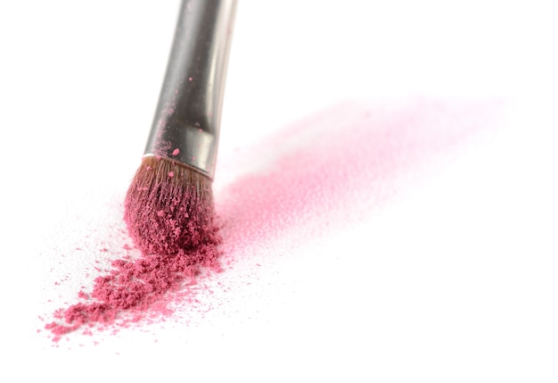 Stroke of eyeshadow made with a makeup brush on watercolor paper isolated on a white background