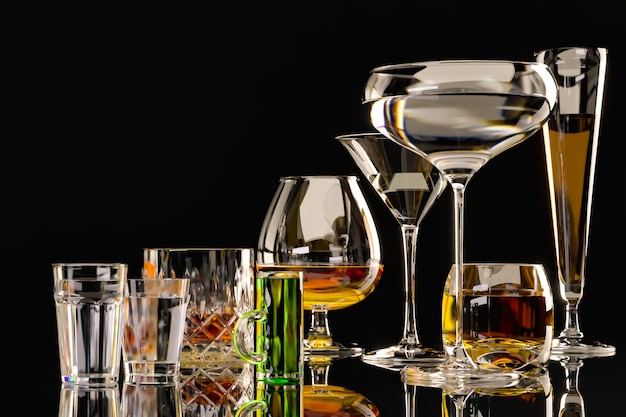 Strong alcoholic drinks, in glasses on a dark background