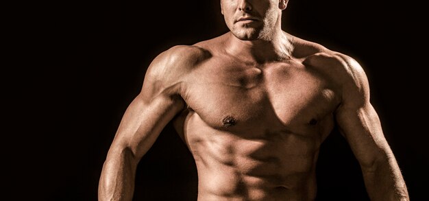 Strong athletic man showing muscular body and sixpack abs. Showing muscular torso.