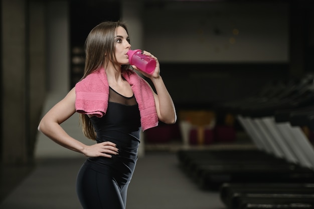 Strong athletic young girl working out in gym