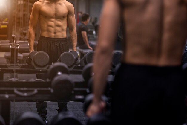  strong bodybuilder athletic fitness man pumping up abs muscles 