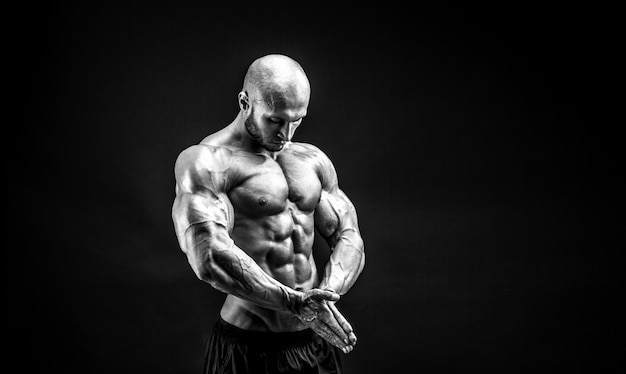 Strong bodybuilder posing and showing muscles