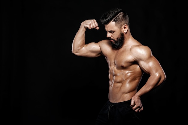 Strong bodybuilder posing in studio