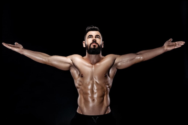 Strong bodybuilder posing in studio