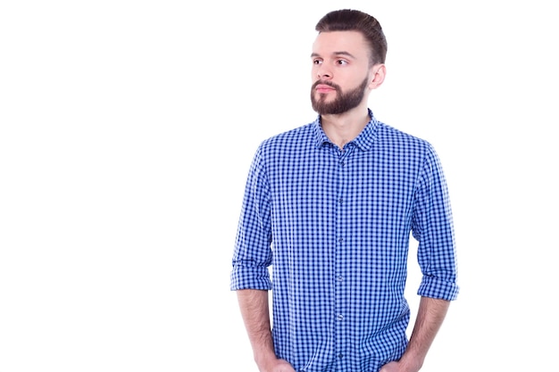 Strong confident handsome and bearded man in casual checkered shirt is posing isolated on white background with copy space for text and advertising