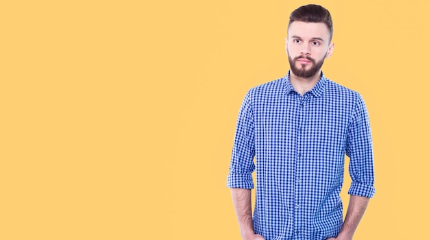 Strong confident handsome and bearded man in casual checkered shirt is posing isolated on white background with copy space for text and advertising