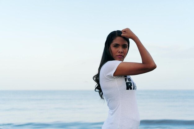 Strong, determined and confident woman with her fist in the air.