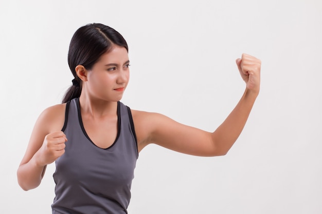 Strong fitness woman punching isolated