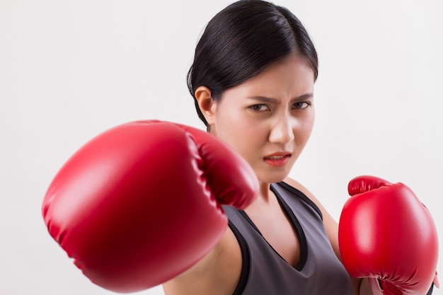 Strong fitness woman punching isolated