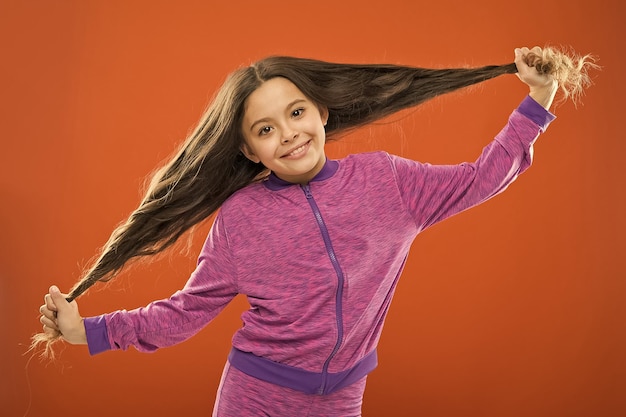 Strong hair concept Kid girl long healthy shiny hair Main thing is keeping it clean Use gentle shampoo and warm water Little girl grow long hair Teaching child healthy hair care habits