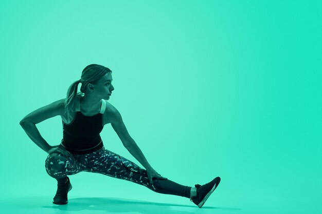 Strong lady lunging under green light