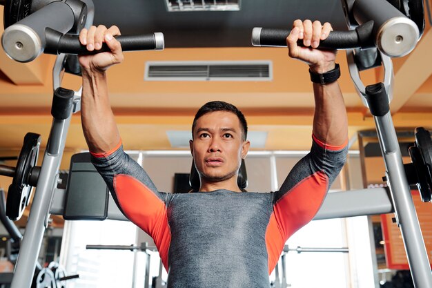 Strong man doing chest exercise