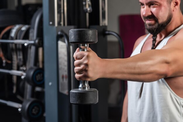 Strong man is training in the gym