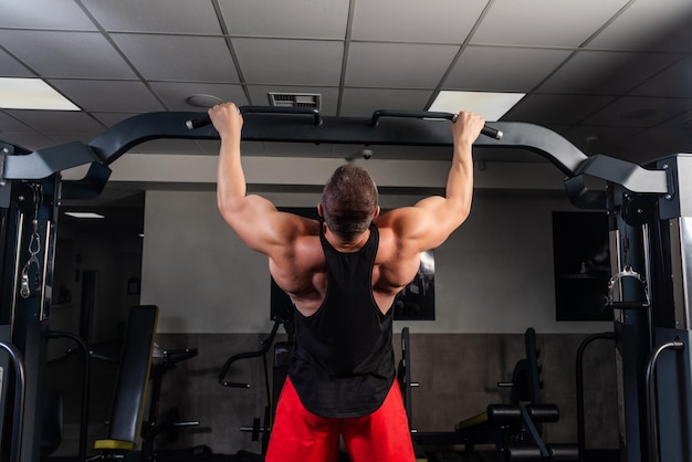 Strong man is training in the gym