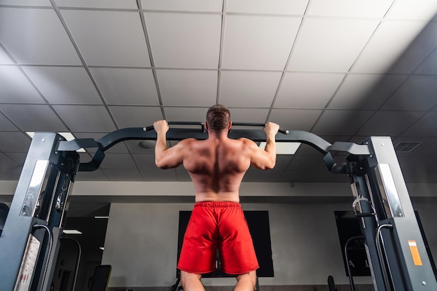 Strong man is training in the gym