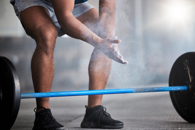 Strong man powder hands and barbell exercise challenge and workout in gym fitness club and body muscle Closeup of bodybuilder chalk and weightlifting grip and training performance and power