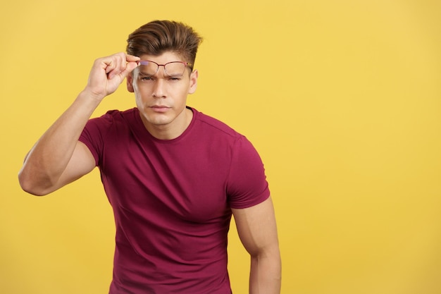 Strong man taking off her eyeglasses to see ahead