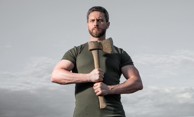 strong man with axe lumberjack man hold ax brutal man on sky background