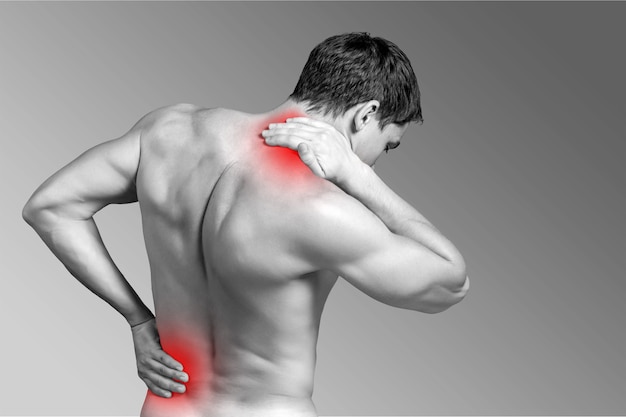 Strong man with neck pain, back view