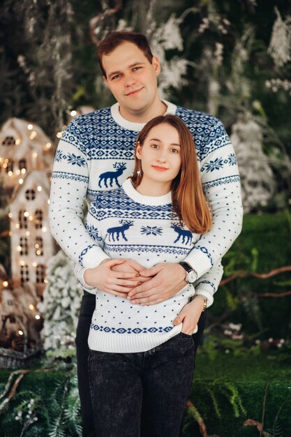 strong man with short dark hair loves pretty young caucasian woman with brown hair in warm sweater