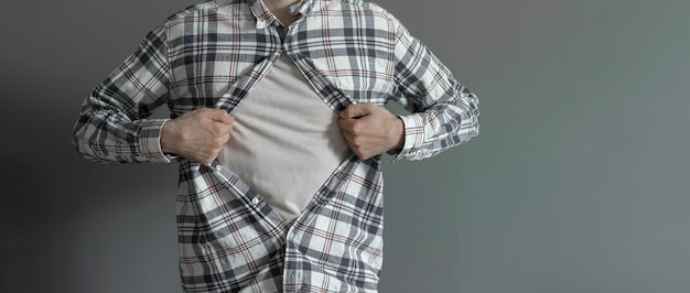 A strong person breaks his shirt and opens shirt as a super hero template mockup