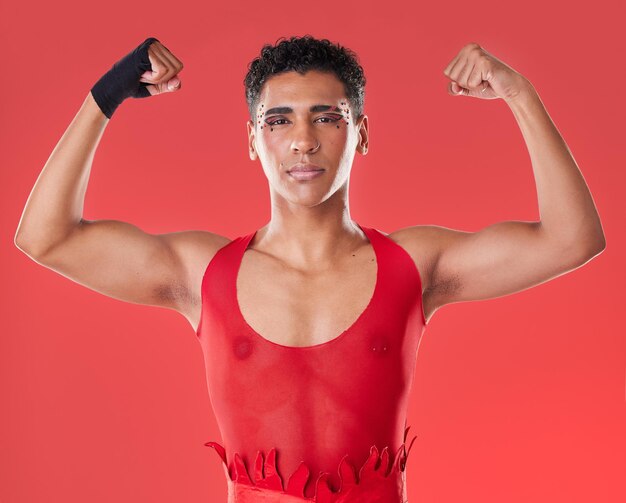 Strong power and portrait of a gay man for boxing isolated on a red background in a studio Strength training and lgbt fighter showing muscle for a fight self defense and sport on a backdrop