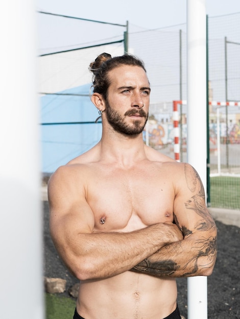 Strong shirtless caucasian man portrait standing outdoor