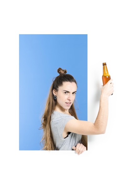 Strong woman holding a beer while showing biceps muscle