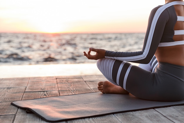 Strong young fitness woman meditates