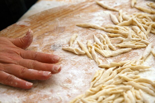 Strozzapreti homemade on wooden table