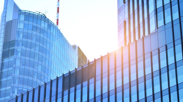 Structural glass wall reflecting blue sky Abstract modern architecture fragment