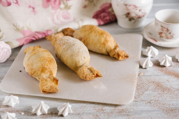 Strudel dessert on the white wooden baclground