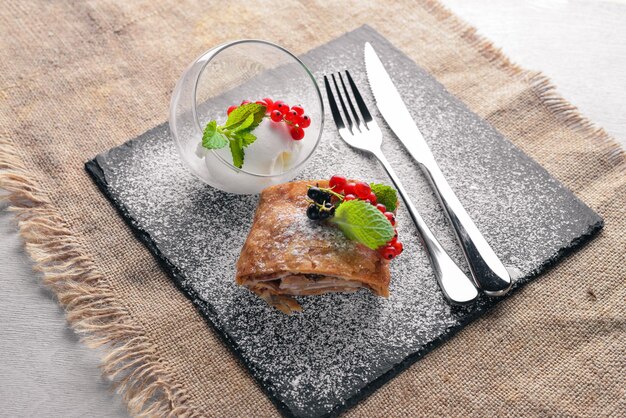 Strudel with fresh berries and ice cream On a wooden background Top review Free space