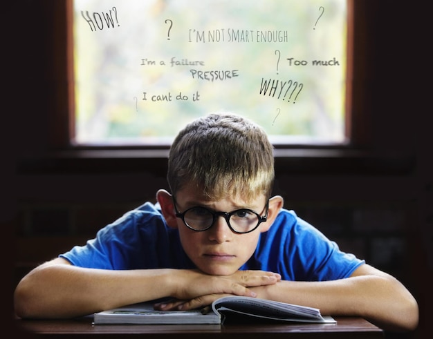 Struggling to learn Learning disabilities Young boy feeling overcome with boredom in the classroom