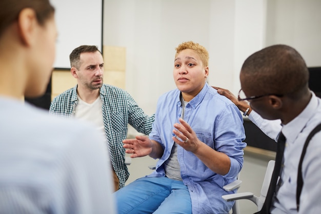 Struggling Woman Sharing in Support Group